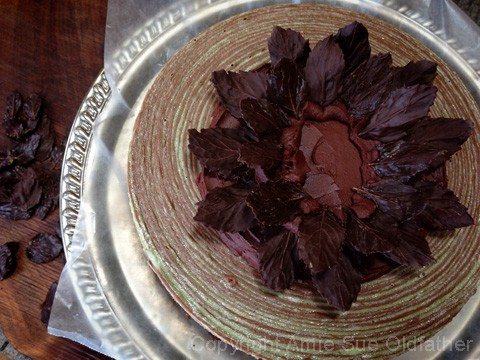 Gently press the ends of the leaves into the ganache, you can put them in at different angles so that you build volume and texture