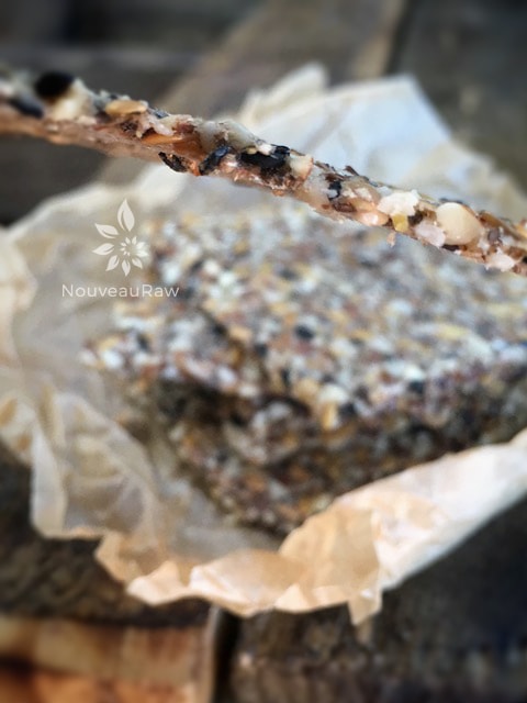 a photo showing you how thin a close up photo of crunchy seedy gluten-free Sesame Onion Almond Flax Crackers are