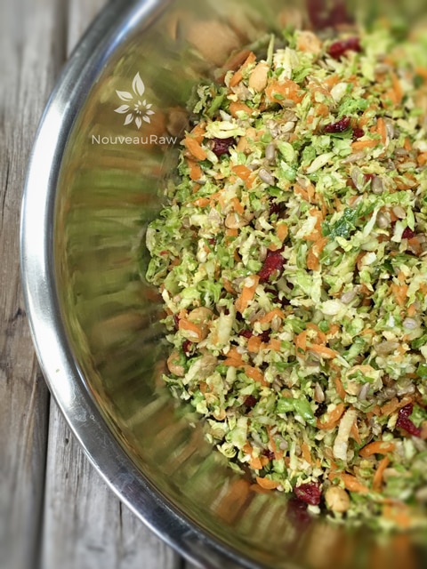 combining everything to make the raw vegan Toasted Sesame Shredded Brussel Sprout Salad 