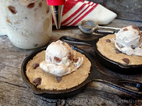 raw vegan gluten-free Chocolate Chip Skillet Cookie served with Ice Cream in a cast iron skillet