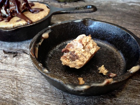 one bite left of raw vegan gluten-free Chocolate Chip Skillet Cookie served with Ice Cream 