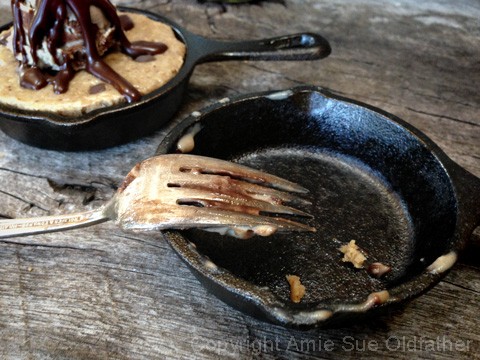eating up the raw vegan gluten-free Chocolate Chip Skillet Cookie served with Ice Cream 