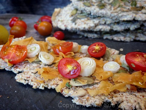 vegan Smoked Gouda Cheese that has been shredded on crackers