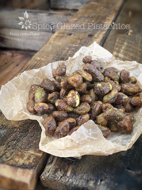 a close of raw Spice Glazed Pistachios displayed on barn wood