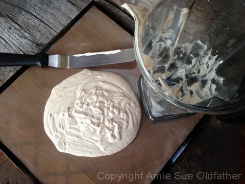 spreading the raw vegan gluten-free phyllo dough on the dehydrator tray
