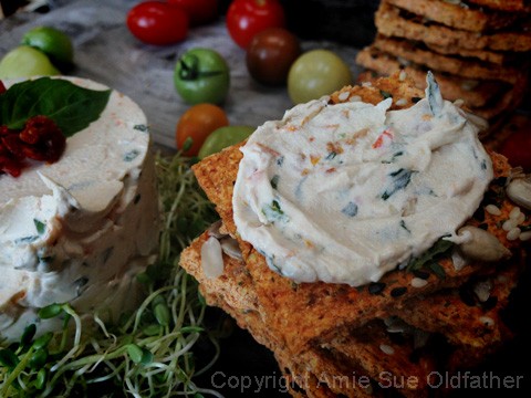 close up raw vegan creamy smooth Sun-dried Tomato and Basil Cheese Spread 