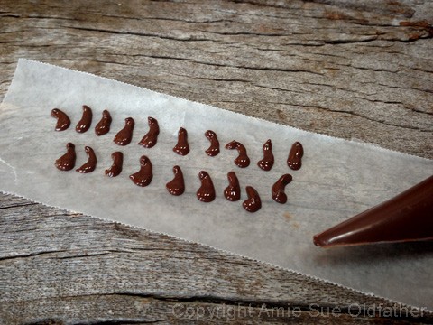  Piping out tiny chocolate pear stems