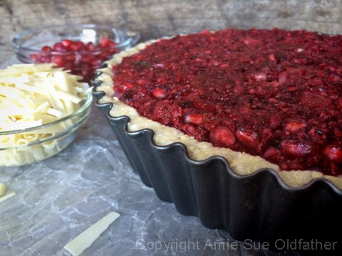 Spread 2 cups of relish on top the cake, Place about 1/4 cup of pomegranate seeds in the very center