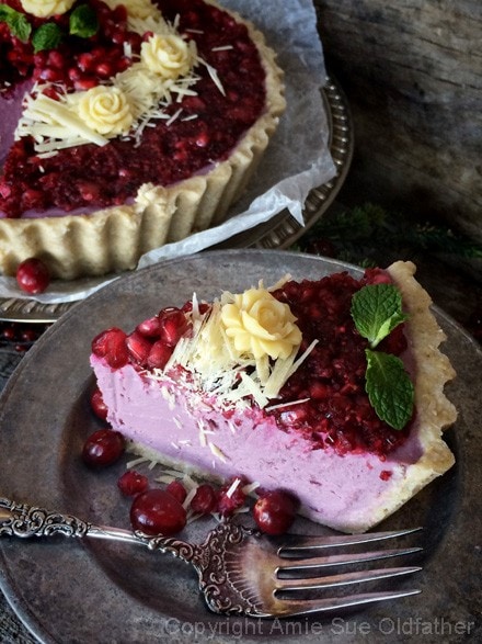 A delicious slice of a Raw Pomegranate and Cranberry Relish Cheesecake, hard to resist