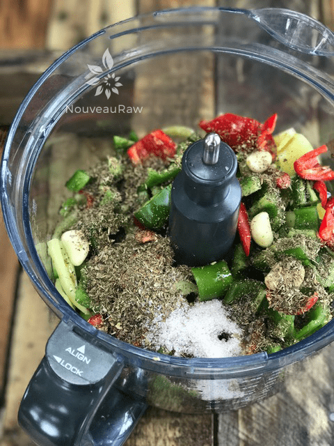 a food processor bowl filled with fresh mixed peppers