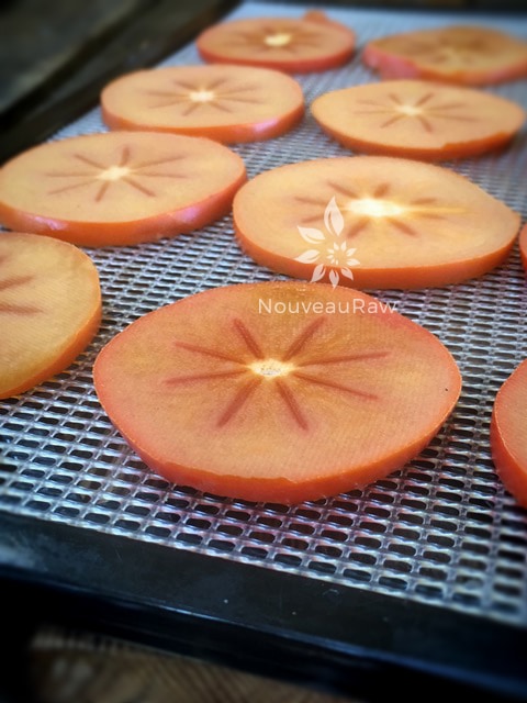 fresh slices of persimmons getting ready for the dehydrator