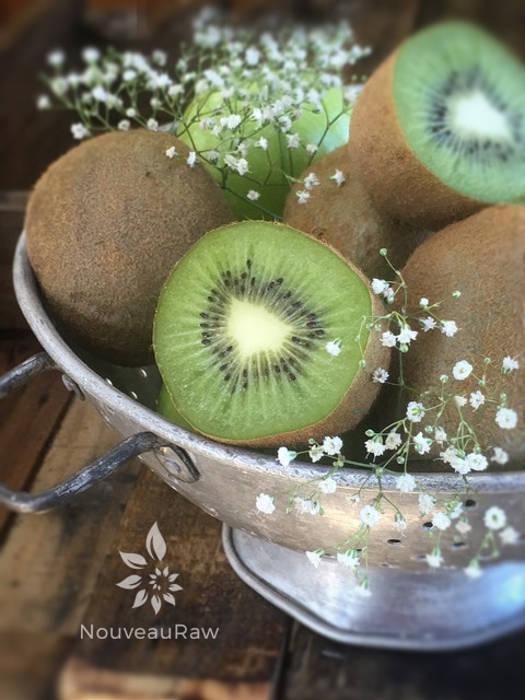 an antique container holding fresh kiwi