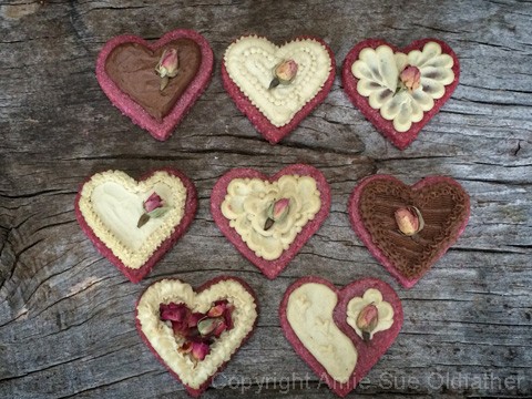 many differently decorated Rosewater Sugar Cookie displayed on wood