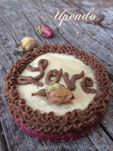 raw vegan Rosewater Sugar Cookie with the word love piped on it