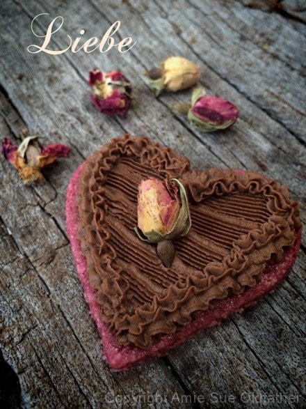 raw vegan Rosewater Sugar Cookie decorated with chocolate frosting