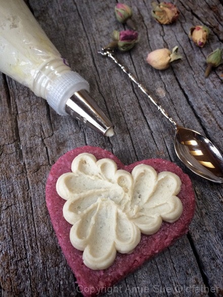 decorating raw vegan Rosewater Sugar Cookies with raw frosting