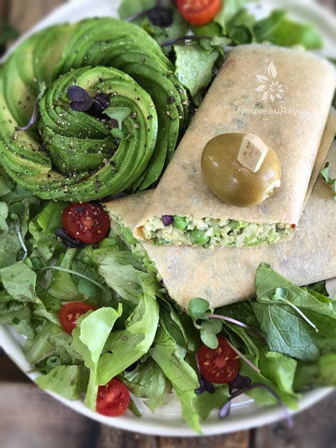 close up of raw vegan Sweet Pea and Brussels Sprout Salad in a coconut wrap