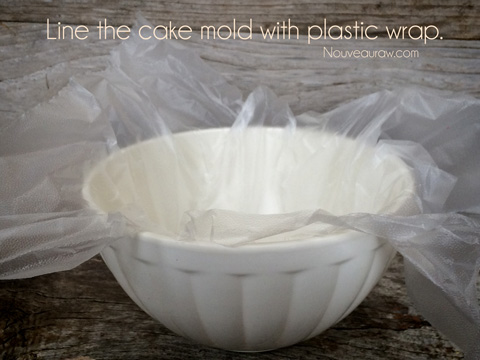 Line the cake mold with plastic wrap