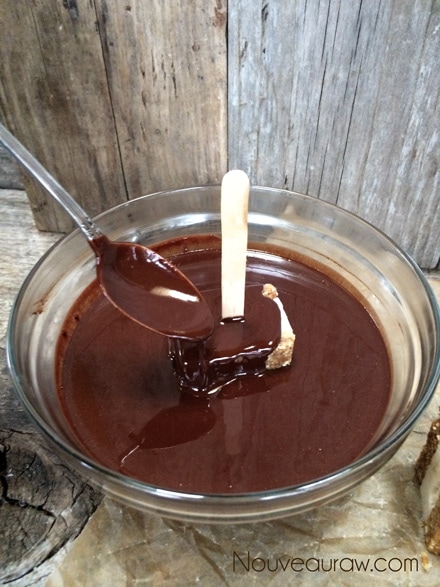 Time for a chocolate bath. Use a spoon to ladle chocolate around the top.