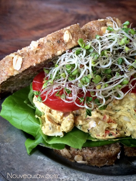 a close up of raw vegan gluten-free Egg Salad Sandwich served on a silver plate