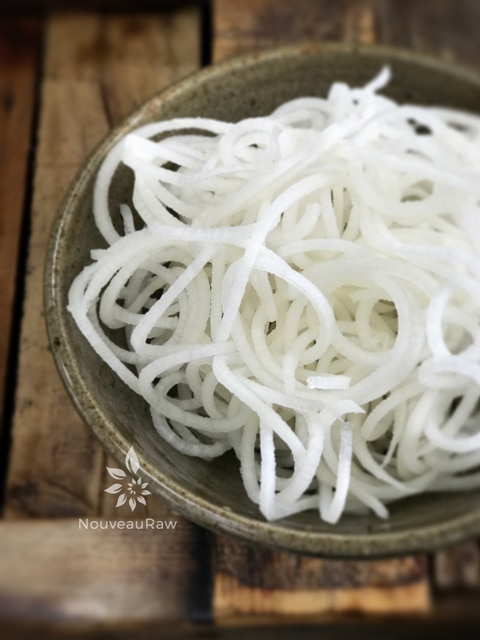 a close up of a bowl of fresh alkaline Jicama Noodles 