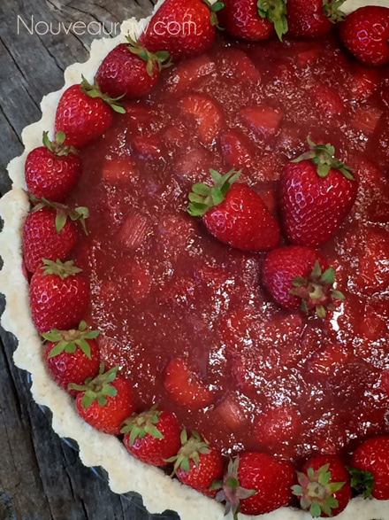 Decorate the Raw Ruby Red Strawberry Rhubarb Cream Pie with fresh strawberries