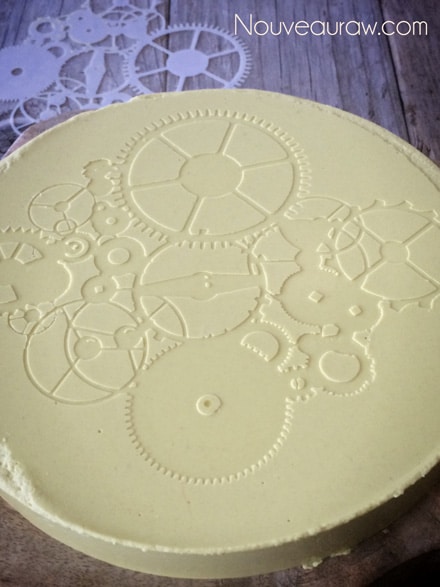 viewing the stencil print on the vegan Sunflower Cheese Wheel