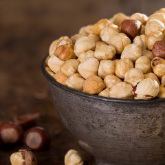 close up of raw hazelnuts in bowl
