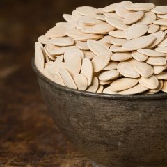 close up of pumpkin-seeds in a bowl