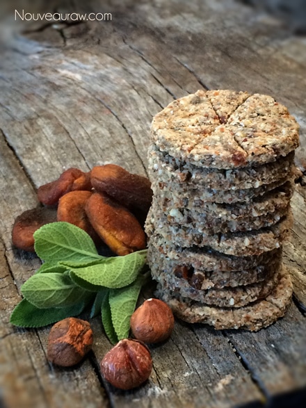 a stack of raw gluten free Apricot Hazelnut and Sage Coastal Crackers displayed on a wooden table