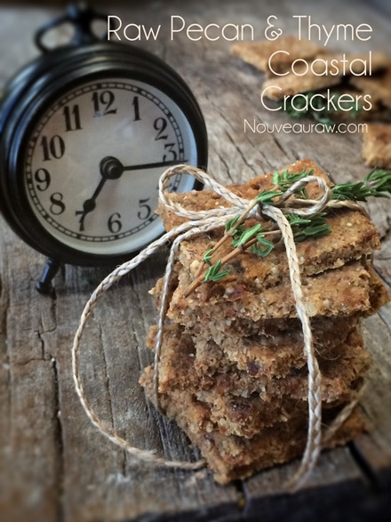 raw vegan gluten free Thyme and Pecan Coastal Crackers displayed with an old fashion clock