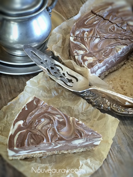 velvety smooth and creamy slice of a single slice of raw vegan Peanut Butter & Chocolate Marble Cheesecake