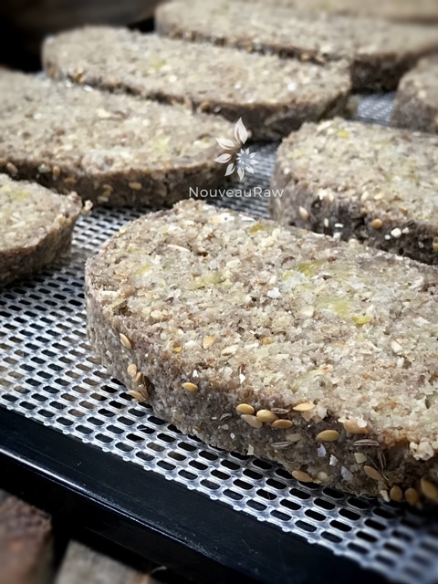 sliced raw vegan gluten-free Sauerkraut and Caraway Bread on dehydrator trays