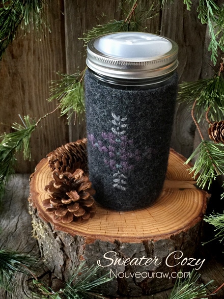 a wool sweater sleeve used to make a jar cozy with a sippy lid on it