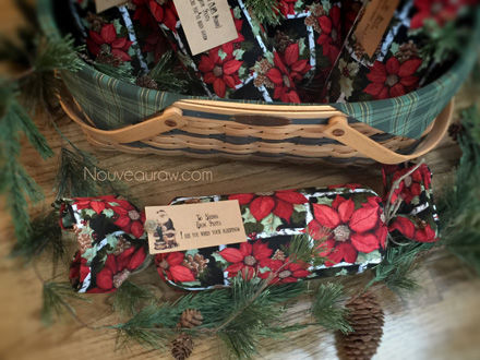 a basket full of cloth wrapped Christmas gifts