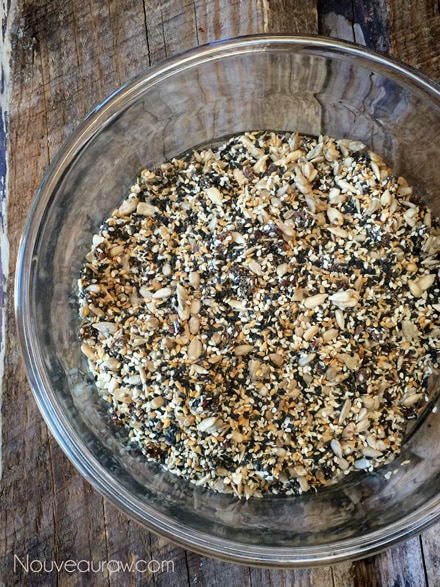 mixing all the ingredients together to make raw vegan grain free Multi-Seeded Crackers in a glass bowl