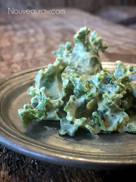 thick crunchy close up of raw vegan Cheesy Kale Chips 