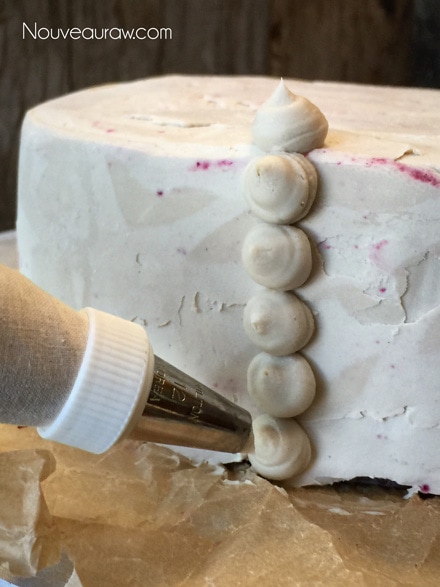 Create a row of frosting dots, starting from the top to the bottom - How to frost a cake