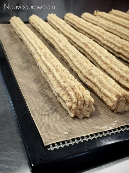 raw vegan gluten free Churro Pastries piped out on the dehydrator tray