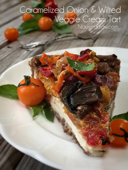raw vegan Caramelized Onion & Wilted Veggie Cream Tart served on a white plate