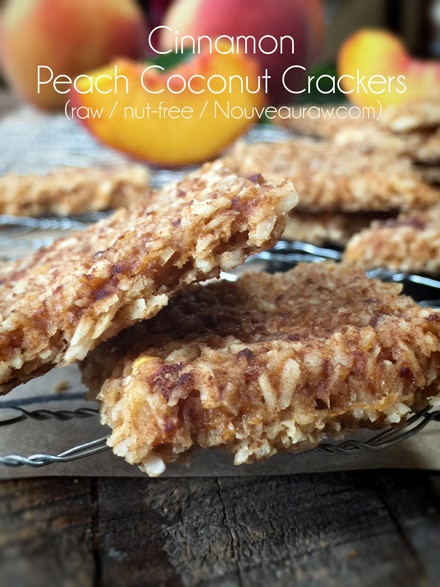 Cinnamon Peach Coconut crackers that are raw and nut-free closeup with peaches