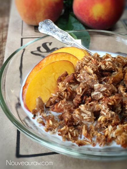 Sweet and tasty Soft n' Chewy Pecan Peach Granola Cereal with fresh sliced peaches in a glass bowl