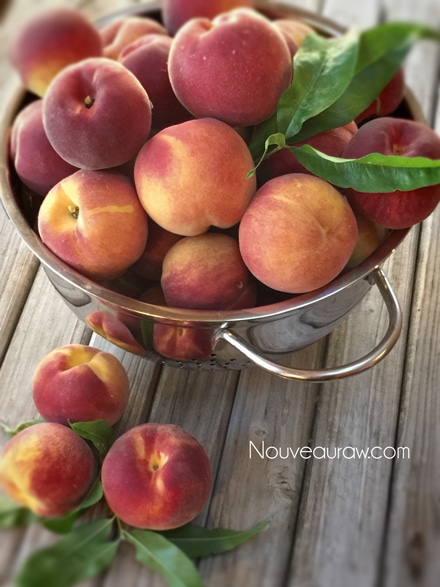 Beautiful ripe peaches in a stainless bowl