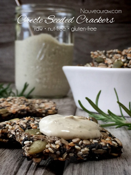 raw nut free gluten free Creole Seeded Crackers displayed on barn wood