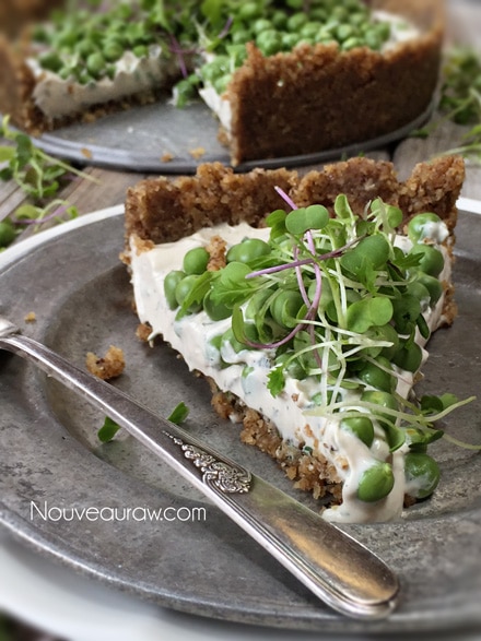 a fresh slice of raw vegan Fresh Herb and Sweet Pea Pie with Balsamic Pepper Crust ready to be enjoyed