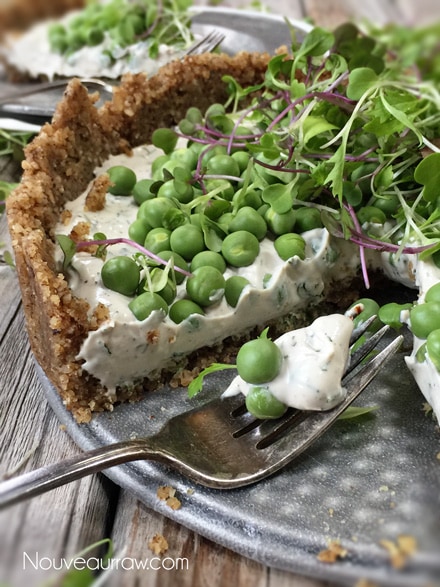 removing a slice of raw vegan Fresh Herb and Sweet Pea Pie with Balsamic Pepper Crust from the pan