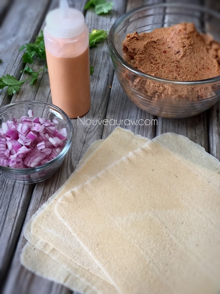 laying out the ingredients to create raw vegan gluten-free "Refried Bean" and "Cheese" Burrito