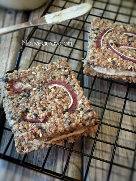 an over view of raw gluten free Sweet Onion Sesame Crackers displayed on a cooling rack