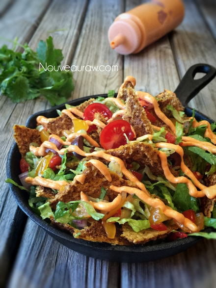 a close up of raw vegan Raw-cho Nachos served in a cast iron skillet