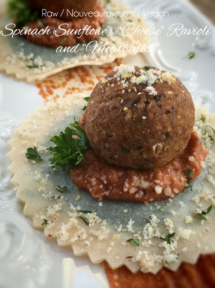 raw vegan Spinach Sunflower "Cheese" Ravioli and "Meatballs" served on a white dish